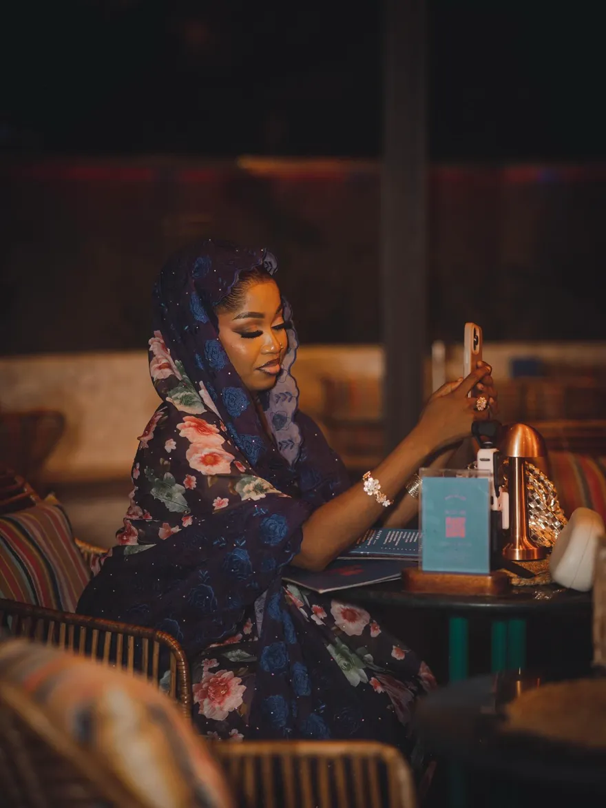 A guest at her table as the evening settles in